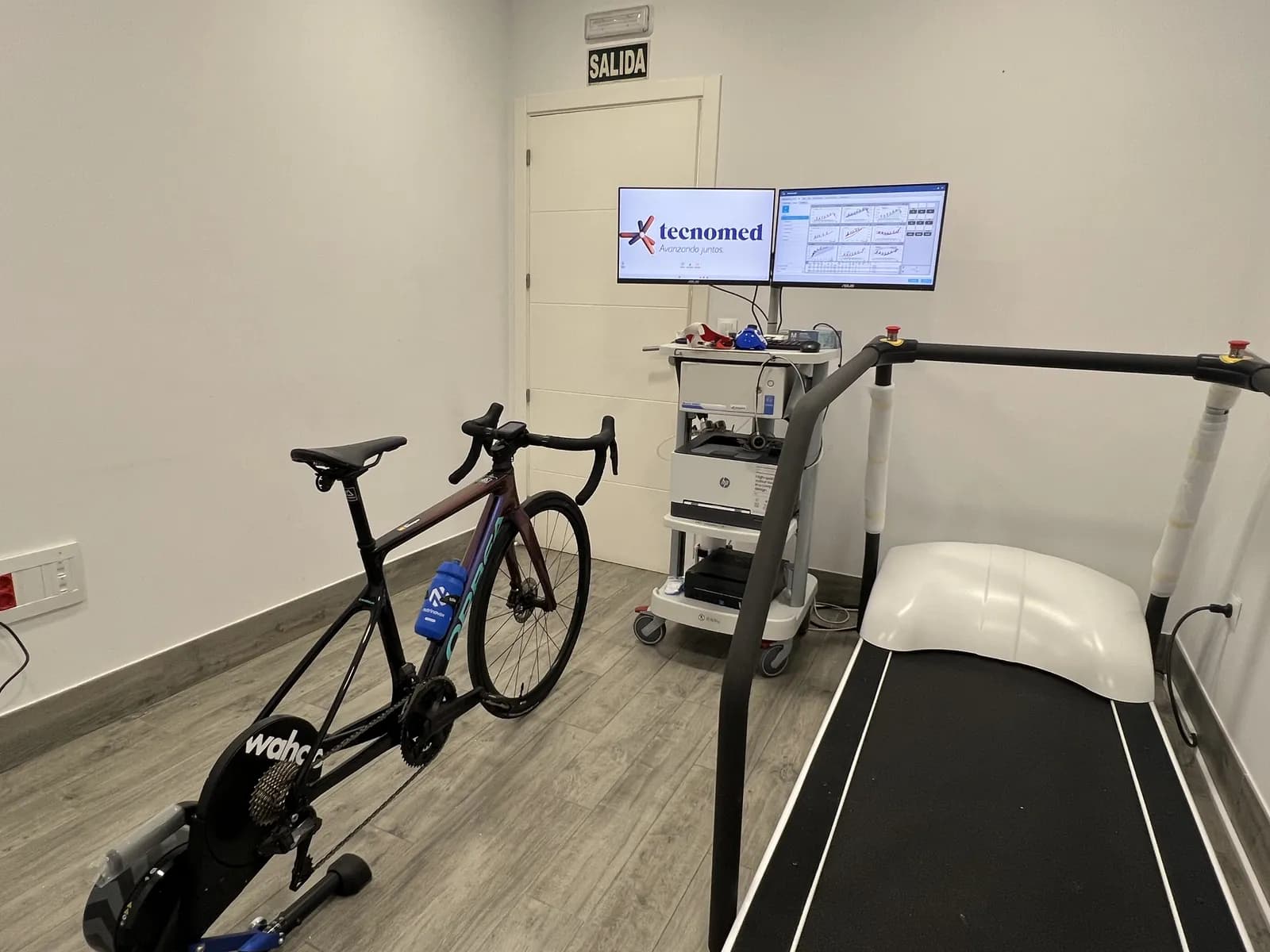 Sala de prueba de esfuerzo con cinta de correr y bicicleta sobre rodillo inteligente integrado en el sistema